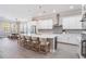 Open concept kitchen featuring a large island with seating, stainless appliances and ample counter space at 16677 Vibrato Ln, Land O Lakes, FL 34638