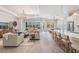Spacious living room featuring modern furnishings, hardwood floors, and an abundance of natural light at 16677 Vibrato Ln, Land O Lakes, FL 34638