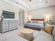 Calm main bedroom with walk-in closet, large bed, sitting area, and tray ceiling at 16677 Vibrato Ln, Land O Lakes, FL 34638