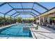 Beautiful screened-in pool and spa area with a spacious deck, perfect for relaxing and entertaining guests at 16677 Vibrato Ln, Land O Lakes, FL 34638