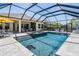 Inviting screened-in pool and spa area with comfortable lounge seating and ample space for relaxation and recreation at 16677 Vibrato Ln, Land O Lakes, FL 34638