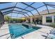 Stunning screened-in pool and spa with a spacious deck and ample seating, perfect for outdoor enjoyment at 16677 Vibrato Ln, Land O Lakes, FL 34638