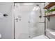 Beautiful tiled shower with a glass door, rainfall shower head, and built-in shelving at 16677 Vibrato Ln, Land O Lakes, FL 34638