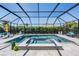 Relaxing screened-in pool area with a spa, lounge chairs, and well-maintained landscaping for privacy at 16677 Vibrato Ln, Land O Lakes, FL 34638