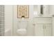 Bright bathroom with shower tub, white cabinets and designer shower curtain at 16971 Warm Hand Ct, Land O Lakes, FL 34638