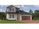 Charming two-story home with landscaped yard, brick driveway and covered entry at 16971 Warm Hand Ct, Land O Lakes, FL 34638