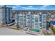 Aerial view of a beachfront condo building with a pool and beach access at 17400 Gulf Blvd # I4, North Redington Beach, FL 33708