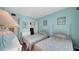 Bright bedroom with two twin beds, white furniture, and an open closet for ample storage at 17400 Gulf Blvd # I4, North Redington Beach, FL 33708