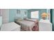A cozy bedroom featuring two twin beds, bright lighting, and a window view at 17400 Gulf Blvd # I4, North Redington Beach, FL 33708