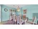A charming dining room featuring a glass table, cushioned chairs, and a decorative hutch at 17400 Gulf Blvd # I4, North Redington Beach, FL 33708