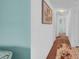 Hallway with white walls, detailed artwork, and access to other rooms at 17400 Gulf Blvd # I4, North Redington Beach, FL 33708