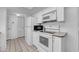 Clean and well-maintained kitchen with white appliances, including a refrigerator, oven, and microwave at 17400 Gulf Blvd # I4, North Redington Beach, FL 33708