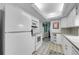 Well-lit kitchen with white appliances and ample counter space, making it an ideal cooking area at 17400 Gulf Blvd # I4, North Redington Beach, FL 33708