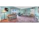 A bright and airy living room with comfortable seating and a balcony access at 17400 Gulf Blvd # I4, North Redington Beach, FL 33708