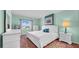 Comfortable primary bedroom with a large window, bright light, and white furniture at 17400 Gulf Blvd # I4, North Redington Beach, FL 33708