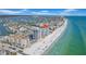 Breathtaking aerial view of beachfront condos, white sand, clear water, and stunning city skyline at 17400 Gulf Blvd # J7, Redington Shores, FL 33708