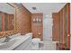 Bathroom with colorful wallpaper, tile floors, glass shower, and white vanity at 17400 Gulf Blvd # J7, Redington Shores, FL 33708