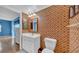 Cozy bathroom with colorful wallpaper, wood floors, and white vanity at 17400 Gulf Blvd # J7, Redington Shores, FL 33708