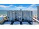 Exterior of a waterfront apartment building on a sunny day with beach access at 17400 Gulf Blvd # J7, Redington Shores, FL 33708