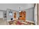 Dining room with tiled floors, a wooden display cabinet, and an adjacent kitchen area at 17400 Gulf Blvd # J7, Redington Shores, FL 33708