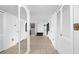 Bright hallway with neutral walls, tile floors, and storage closets at 17400 Gulf Blvd # J7, Redington Shores, FL 33708