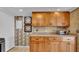 Kitchen featuring granite countertops, wooden cabinets, and tiled backsplash at 17400 Gulf Blvd # J7, Redington Shores, FL 33708