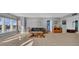 Bright living room featuring tile floors, large windows, and a comfortable seating area at 17400 Gulf Blvd # J7, Redington Shores, FL 33708