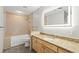 Bathroom featuring a granite countertop, sleek vanity, and large illuminated mirror at 175 2Nd S St # 907, St Petersburg, FL 33701