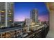 High-rise view of the city skyline at dusk from a private balcony with wrought iron at 175 2Nd S St # 907, St Petersburg, FL 33701