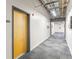 Apartment hallway featuring carpeted floor, neutral walls, and a wooden door at 175 2Nd S St # 907, St Petersburg, FL 33701