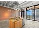 Modern kitchen island with stainless steel appliances and exposed brick, offering scenic city views at 175 2Nd S St # 907, St Petersburg, FL 33701