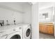 Laundry room featuring modern washer and dryer with access to a sleek bathroom at 175 2Nd S St # 907, St Petersburg, FL 33701