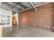 Large brick wall and concrete floors in this loft-style living room with storage at 175 2Nd S St # 907, St Petersburg, FL 33701
