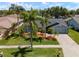 Aerial view of a home featuring lush landscaping, a spacious lawn, and a well-maintained exterior at 1805 Stable Trl, Palm Harbor, FL 34685