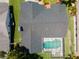 An aerial view displays a house with a dark roof and a private screened-in backyard pool at 1805 Stable Trl, Palm Harbor, FL 34685