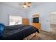 Bedroom with carpet floors features a large window and offers en-suite bathroom at 1805 Stable Trl, Palm Harbor, FL 34685