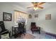 Comfortable bedroom with natural light, a ceiling fan, and view to the backyard at 1805 Stable Trl, Palm Harbor, FL 34685