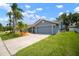 Charming single-Gathering home features an attached two-car garage, mature trees, and a well-maintained lawn at 1805 Stable Trl, Palm Harbor, FL 34685