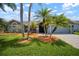 Beautiful home boasts mature landscaping, creating a welcoming curb appeal, with a covered entry at 1805 Stable Trl, Palm Harbor, FL 34685