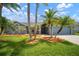 Beautiful home boasts mature landscaping, creating a welcoming curb appeal, with a covered entry at 1805 Stable Trl, Palm Harbor, FL 34685