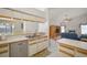 Kitchen features a breakfast bar, stainless steel dishwasher, and flows to the living room at 1805 Stable Trl, Palm Harbor, FL 34685
