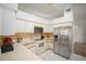 Efficient kitchen featuring white appliances, ample counter space, and tile flooring at 1805 Stable Trl, Palm Harbor, FL 34685