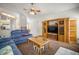Spacious living area with a ceiling fan, cozy furniture, and a view to the kitchen at 1805 Stable Trl, Palm Harbor, FL 34685
