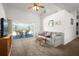 Bright living room features sliding glass doors to the pool area and neutral decor at 1805 Stable Trl, Palm Harbor, FL 34685
