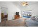 A living room features neutral tones, ceiling fan, and patio doors that provides bright natural light at 1805 Stable Trl, Palm Harbor, FL 34685