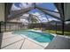 An outdoor pool with a screened enclosure lets you enjoy the water any time, rain or shine at 1805 Stable Trl, Palm Harbor, FL 34685