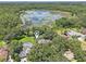 Beautiful aerial view of a luxury home nestled in a lush landscape near a tranquil lake at 1927 Curry Rd, Lutz, FL 33549