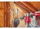 Attic storage space with exposed insulation and rafters at 1927 Curry Rd, Lutz, FL 33549