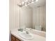 Neutral bathroom with modern lighting, vanity, and ample counter space at 1927 Curry Rd, Lutz, FL 33549