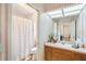 Bright bathroom with a shower, sink, vanity, and nice tile at 1927 Curry Rd, Lutz, FL 33549